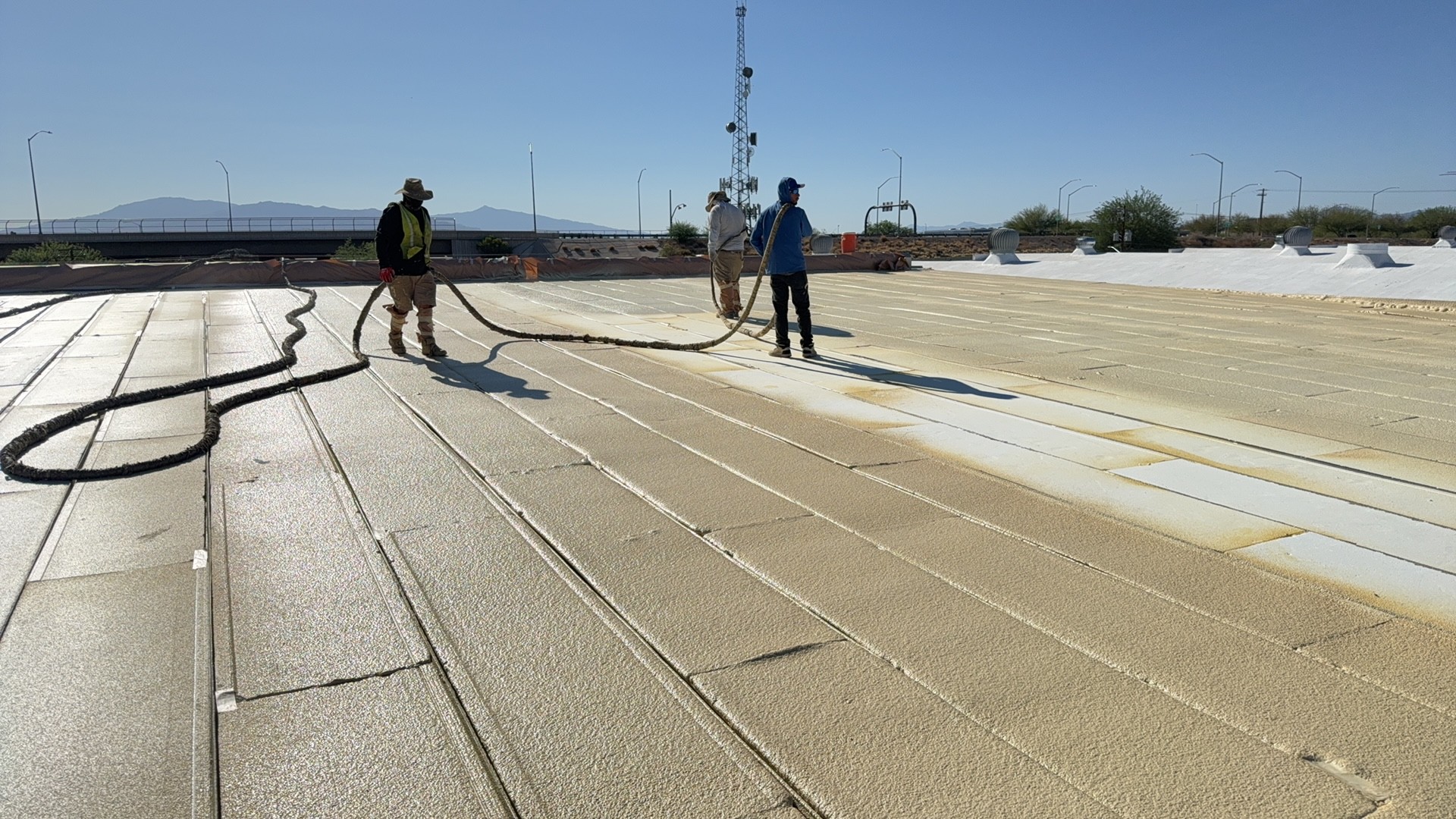 Spray polyurethane foam application on a large commercial roof in Tucson 85719