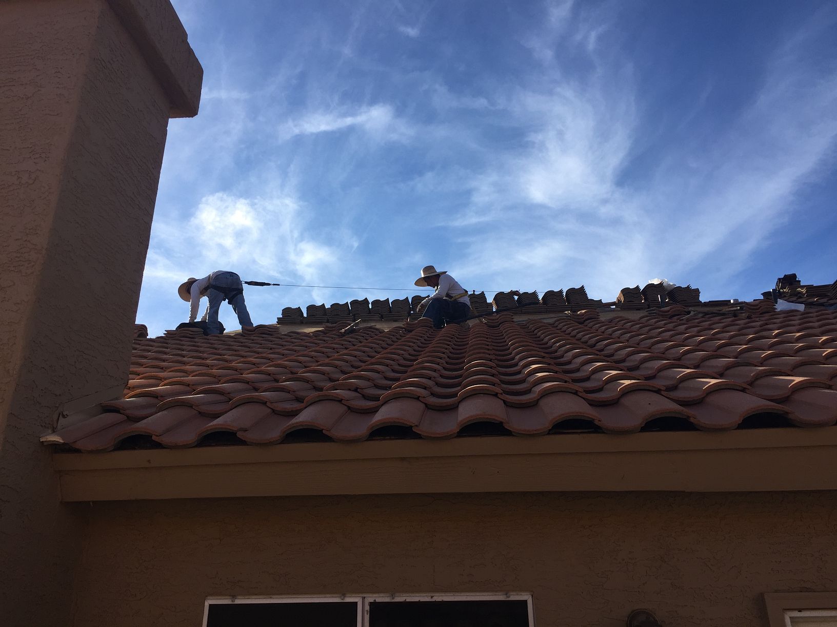 Concrete tile · Scottsdale · May 2026 — Cracked field tile and lifted ridge course after a microburst — active drip staining the master bedroom ceiling.