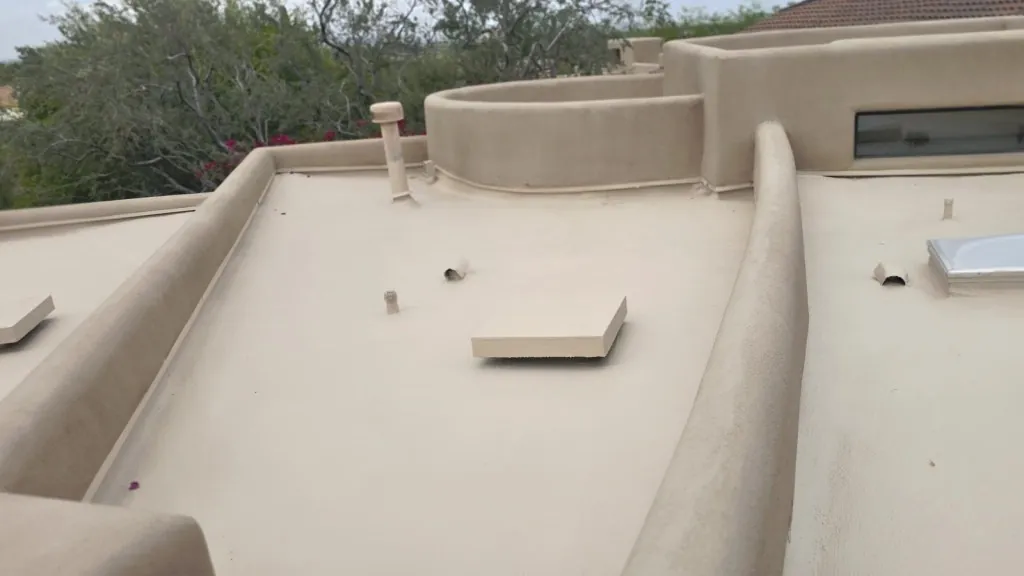 KY-KO Roofing crew recoating a flat foam roof in the Phoenix metro area