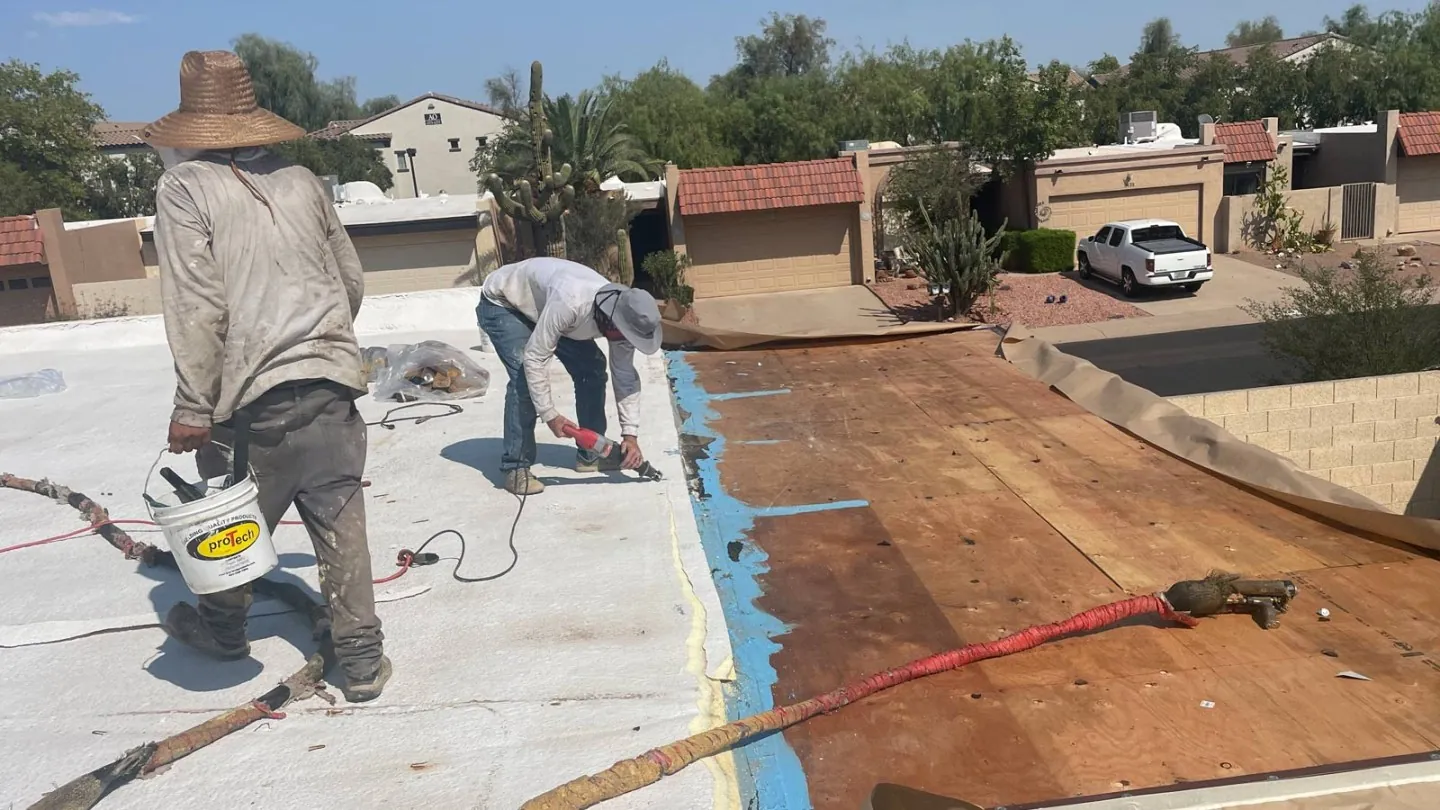 A licensed KY-KO roofer inspecting a Phoenix-area roof for storm damage