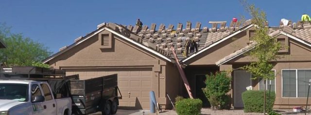 A team of KY-KO roofers works on top of this Valley home, laying out tile to protect the underlayment and roof structure.