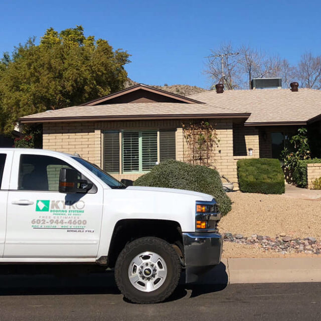 A KY-KO truck sits parked in front of this Phoenix home as the roofer starts the roof's free checkup.